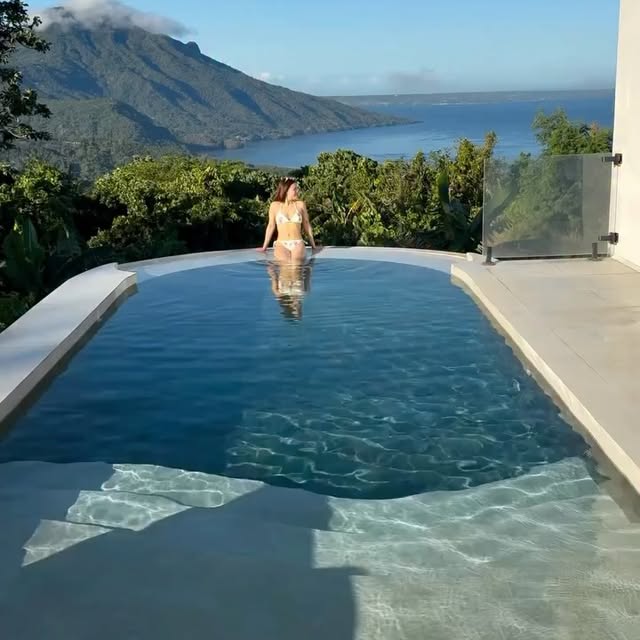 Oval plunge pool with lake and mountain view